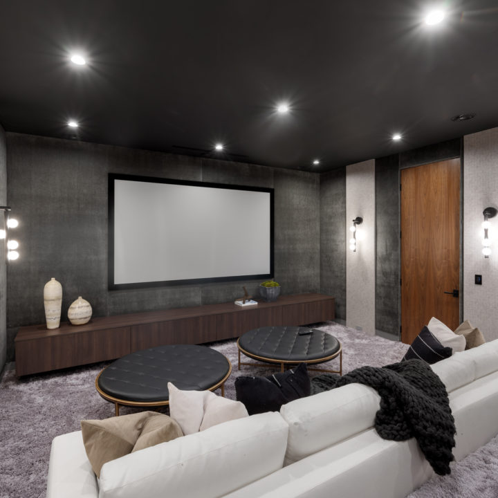 A white sectional sofa in a modern room with elegant gray walls