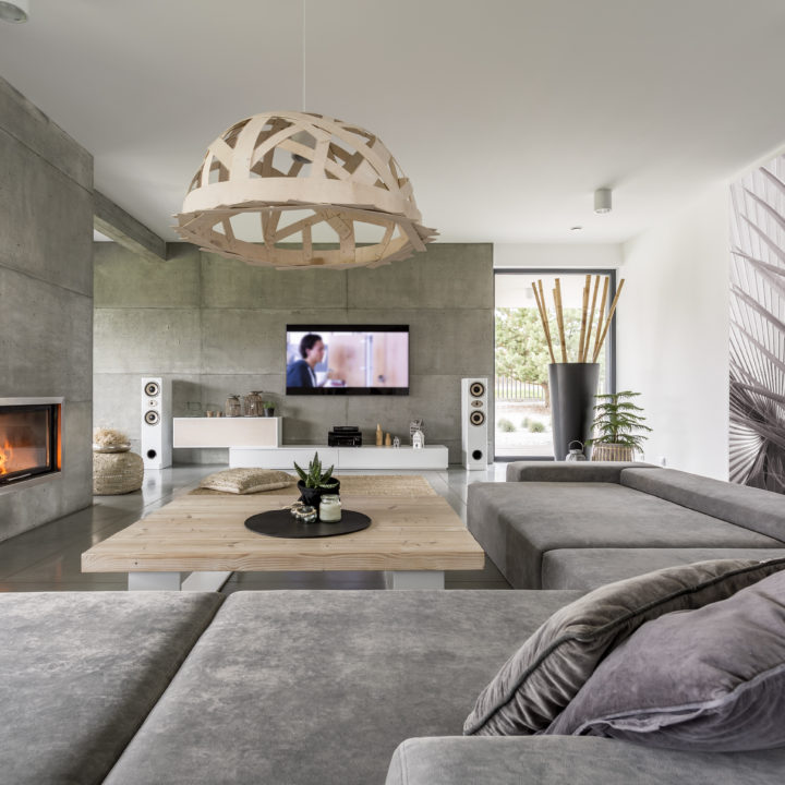 Concrete living room with fireplace and big sofa