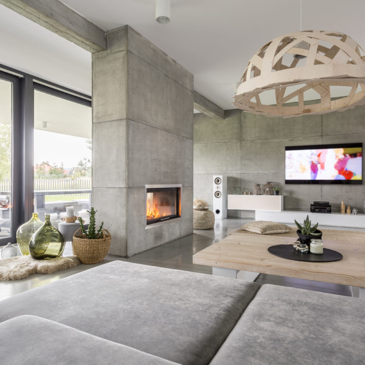 Spacious cozy living room with big windows and fireplace
