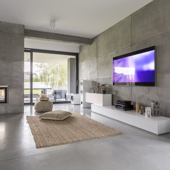 Tv living room with window, fireplace and concrete wall effect